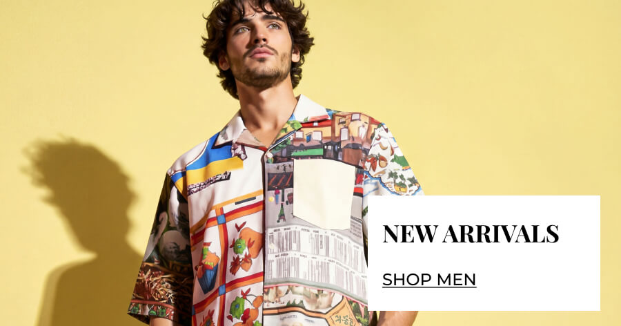 Male model wearing a colorful graphic print short-sleeve shirt against yellow background, with "New Arrivals - Shop Men" text overlay