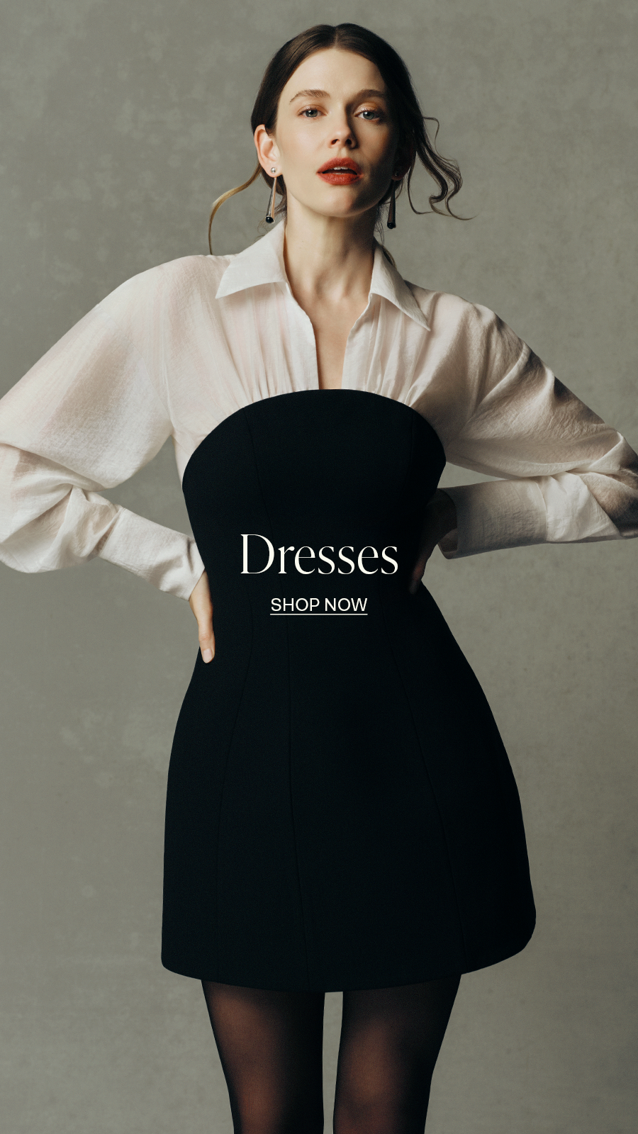Woman wearing a black strapless mini dress over a white long-sleeve shirt, with "Dresses - Shop Now" text overlay