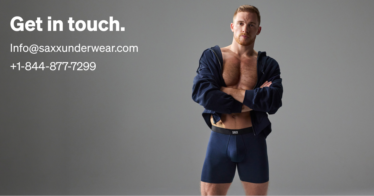 Man modeling SAXX navy blue boxer briefs and open hoodie, with contact information text overlay on gray background.