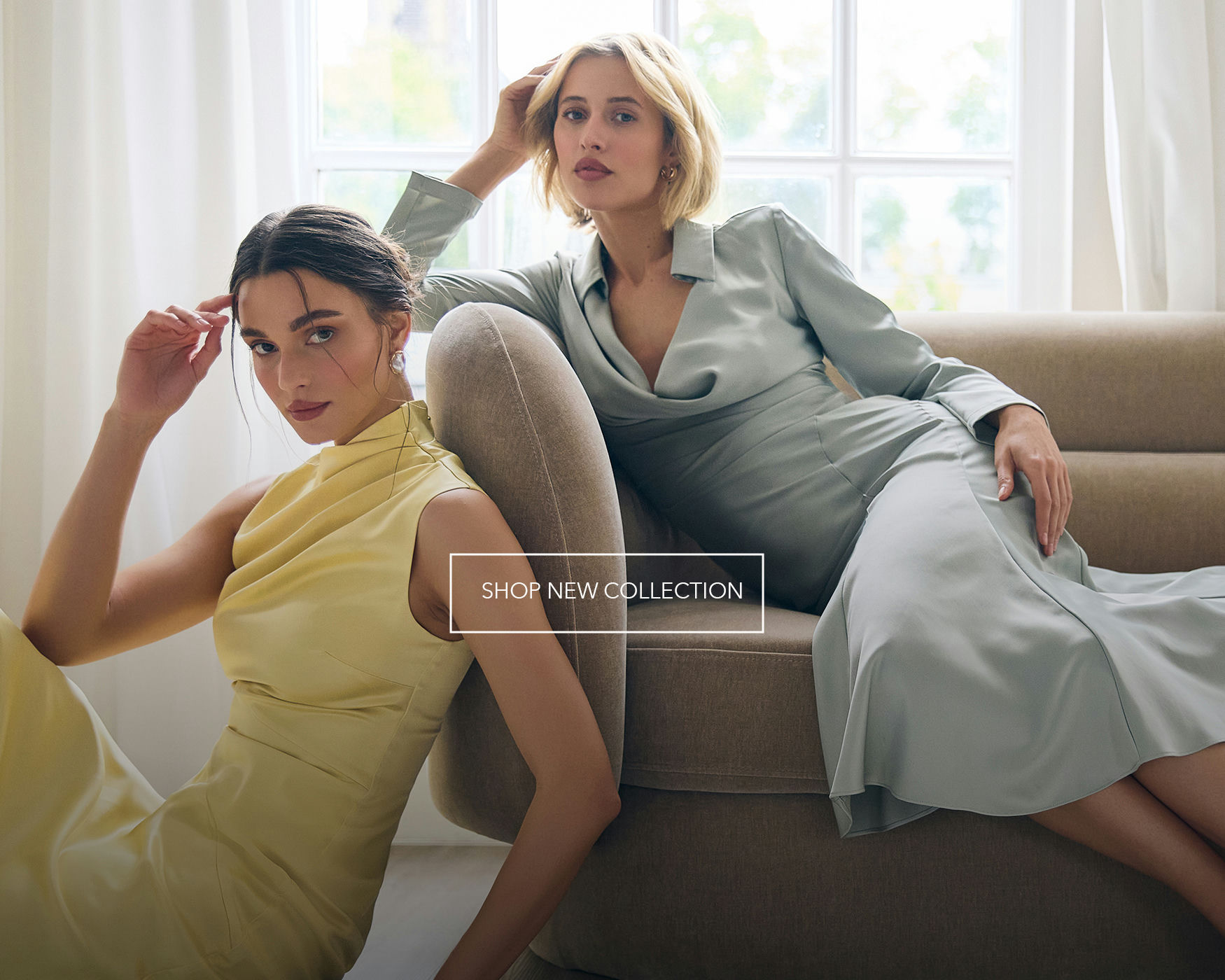 Two female models posing on a beige armchair, one in a yellow dress and one in a sage green outfit, with a "Shop New Collection" banner.