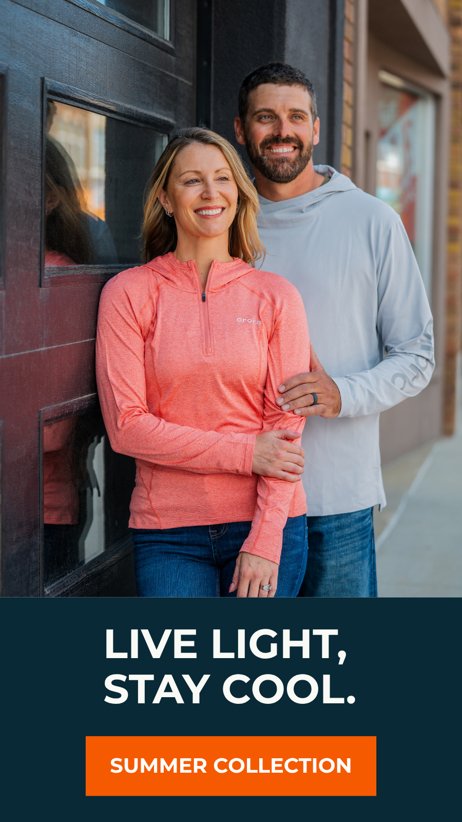 A couple smiling outdoors wearing lightweight hooded pullovers; woman in coral, man in gray, with "Live Light, Stay Cool - Summer Collection" text below.