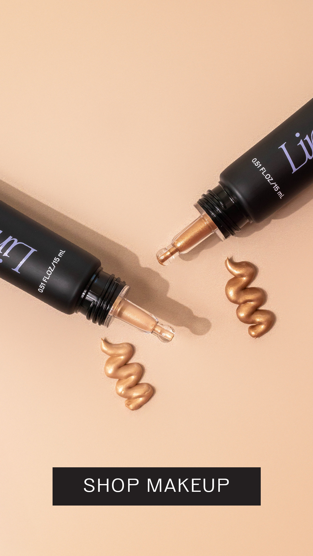 Two open black makeup tubes with dropper applicators showing gold and beige liquid highlighter swatches on a peach background, with "Shop Makeup" text banner below.