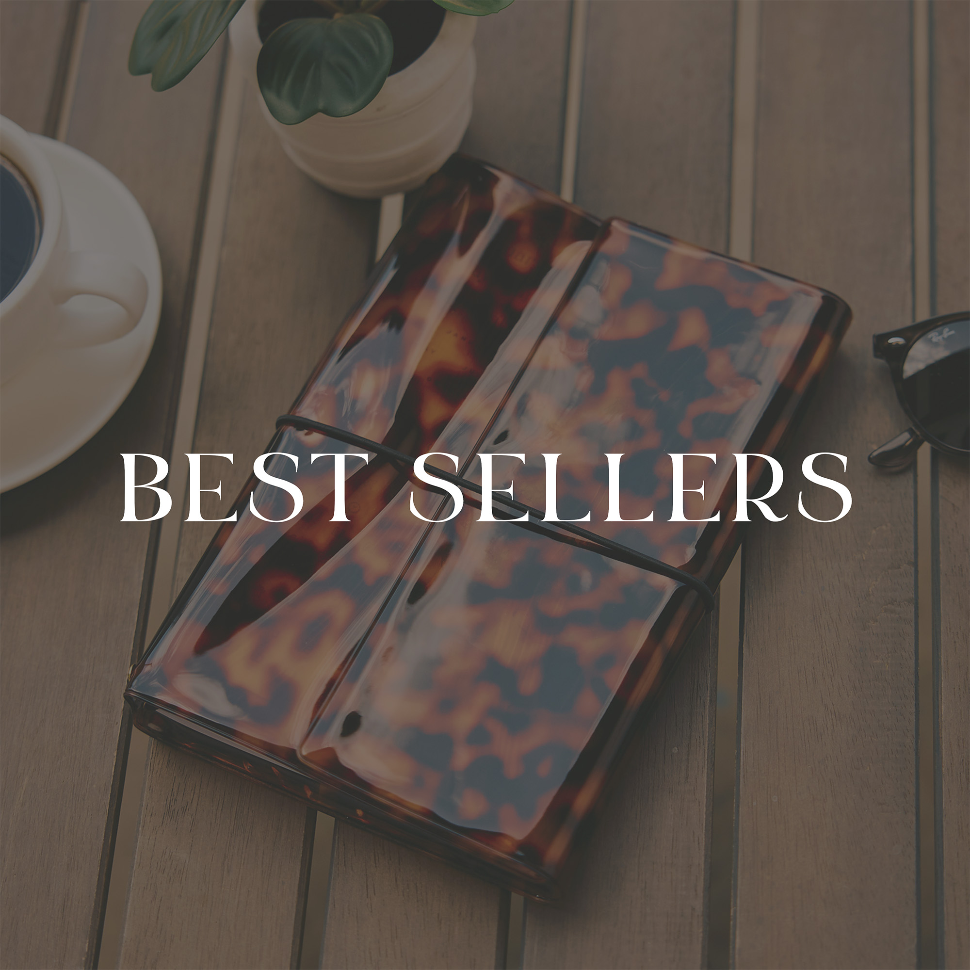 Tortoiseshell card holder on wooden table with coffee cup, plant, and sunglasses, overlaid with "Best Sellers" text
