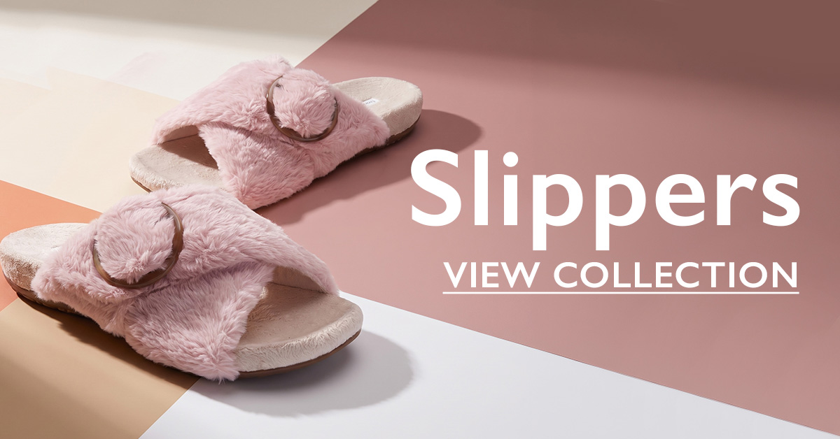 Pink fluffy slide slippers with metal ring buckle on a pastel background, with text "Slippers - View Collection"