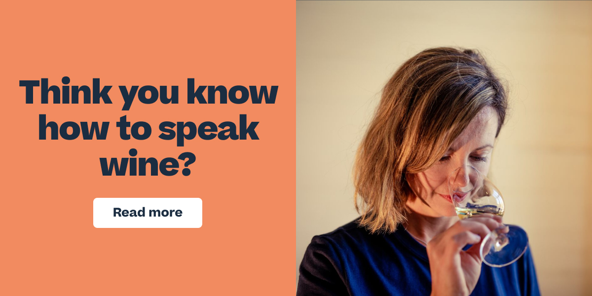 Woman smelling a glass of white wine next to text reading "Think you know how to speak wine? Read more"