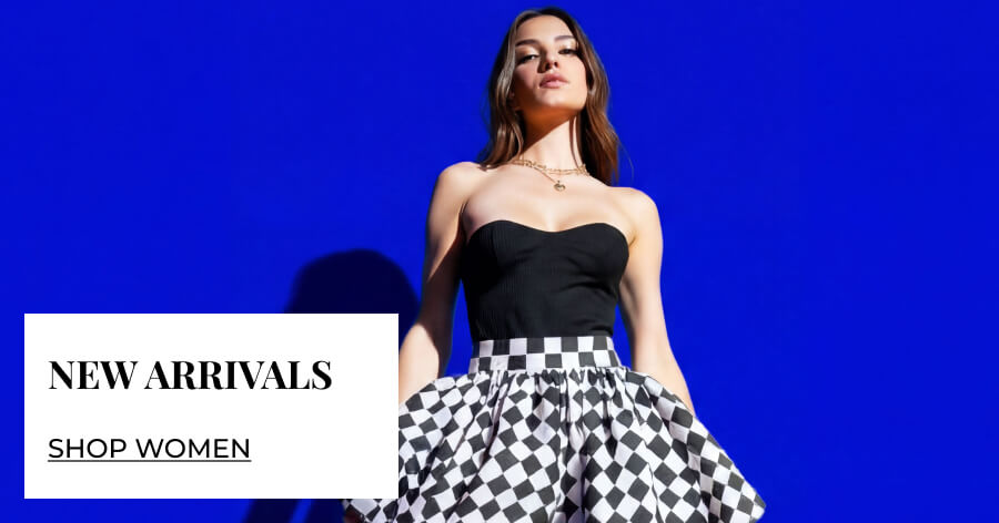 A woman wearing a black strapless top and checkered skirt poses against a blue background, with "New Arrivals - Shop Women" text overlay.