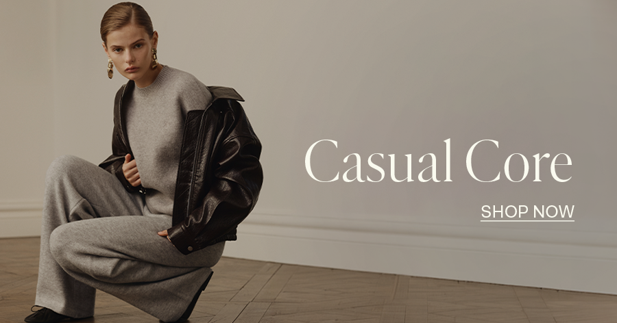 ```html<img src="image.jpg" alt="Person in grey outfit with leather jacket sitting on the floor, text reads 'Casual Core, Shop Now'">```