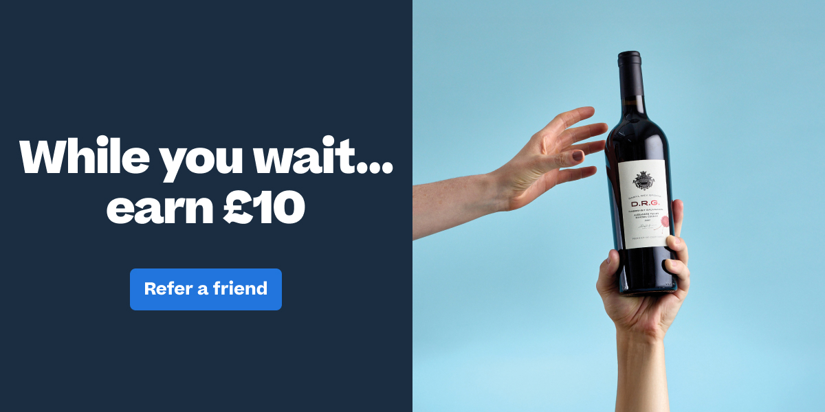 Two hands holding a D.R.G. wine bottle with "While you wait... earn £10 - Refer a friend" promotional text.