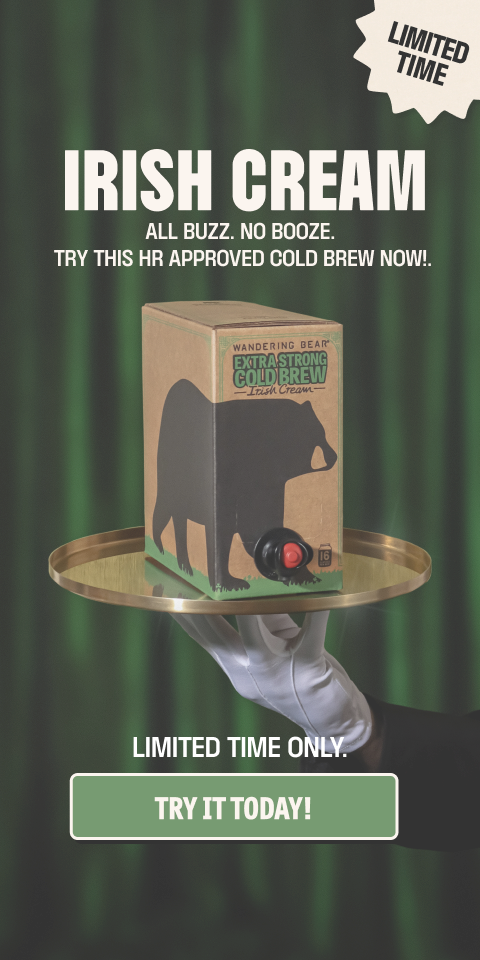 ```html
<img src="image.jpg" alt="Advertisement for Wandering Bear Extra Strong Cold Brew Irish Cream. The box is shown on a tray held by a gloved hand. Text reads 'Irish Cream. All buzz. No booze. Try this HR approved cold brew now!' and 'Limited time only. Try it today!'" />
```