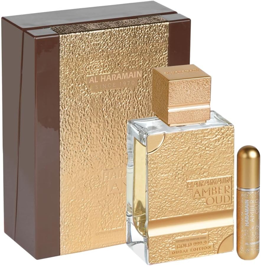 Al Haramain Amber Oud Gold 999.9 Dubai Edition perfume bottle with golden textured packaging and travel-size spray