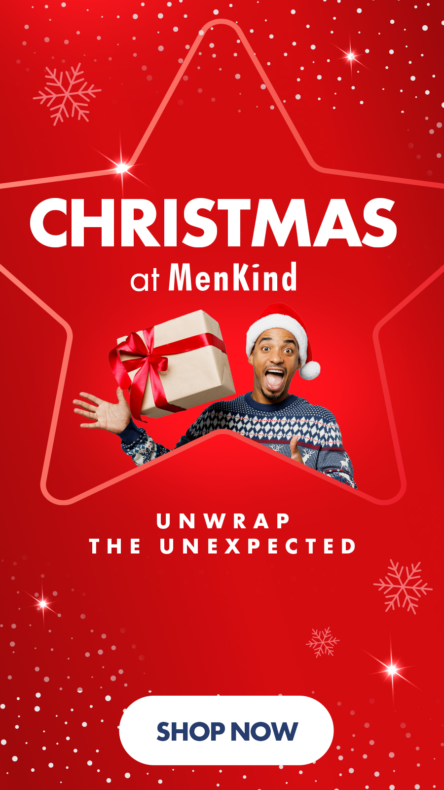 Red Christmas-themed MenKind advertisement with a person in a Santa hat holding a gift box. Text reads "CHRISTMAS at MenKind" and "UNWRAP THE UNEXPECTED."