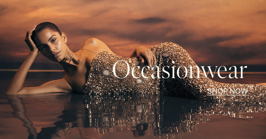 ```html
<img src="image.jpg" alt="Person in a sparkling gown lying in water with 'Occasionwear' and 'Shop Now' text overlayed." />
```